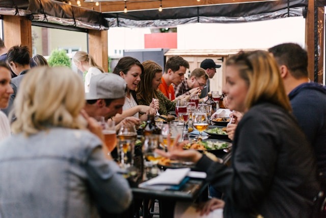 A large group of people eating a meal.
